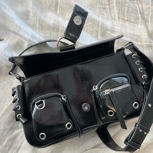 Black shoulder bag with edgy silver loops